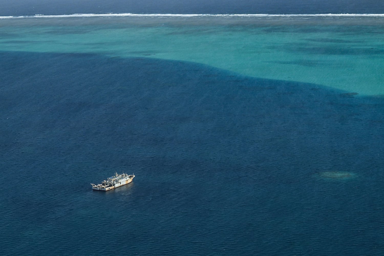 Vessels identified by the Philippine Coast Guard as maritime militia are seen inside the lagoon of the Scarborough Shoal, in the South China Sea during an aerial reconnaissance flight on Feb. 18, 2025.