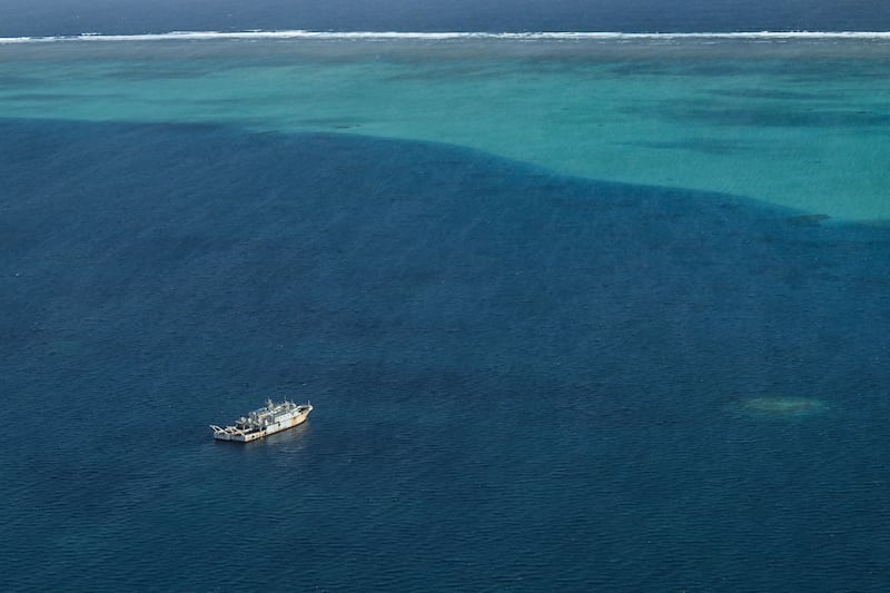 Vessels identified by the Philippine Coast Guard as maritime militia are seen inside the lagoon of the Scarborough Shoal, in the South China Sea during an aerial reconnaissance flight on Feb. 18, 2025.