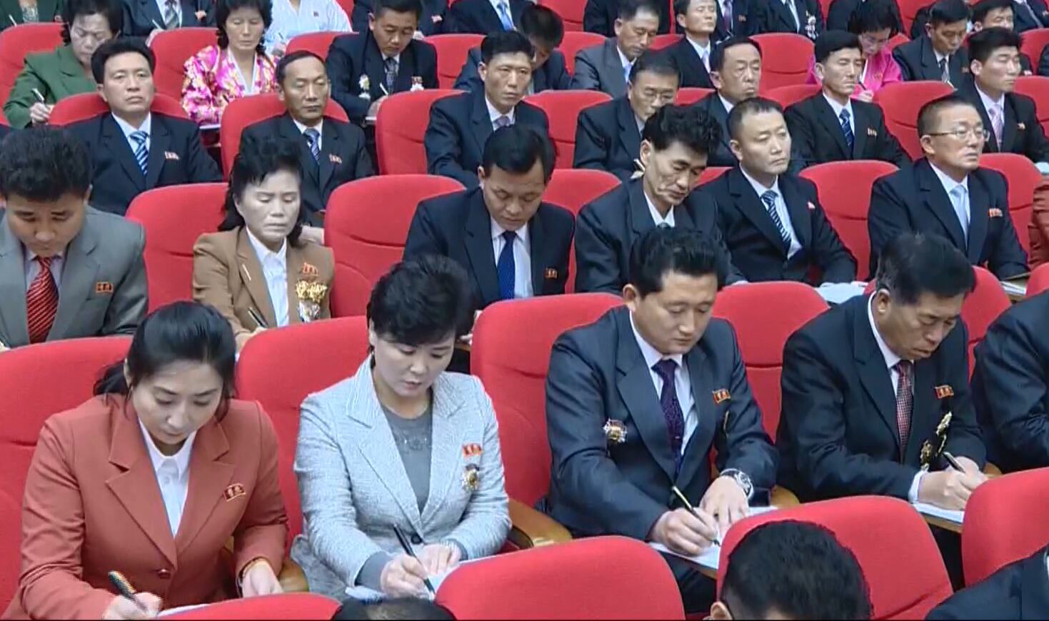 사진은 당대회 참석자들이 김정은 위원장의 개회사를 들으며 수첩에 받아적는 모습.