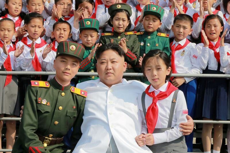 Schoolchildren stand beside Kim Jong Un as he arrives to attend "We Are the Happiest in the World," a performance by schoolchildren to celebrate the 70th anniversary of the founding of the Korean Children's Union, in this photo released June 8, 2016. (Reuters/KCNA)