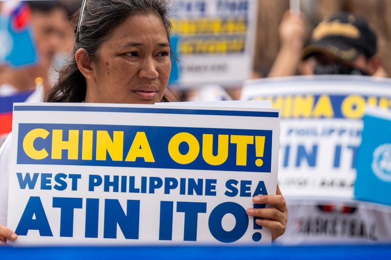 A woman holds a placard during a protest marking the 8th anniversary of the 2016 arbitration ruling over China's claims in the South China Sea, in Quezon City, Philippines, July 12, 2024. "Atin ito!" means "This is ours!" in Tagalog.