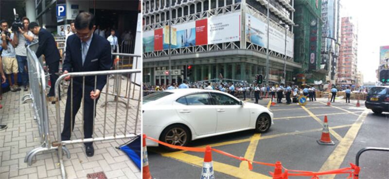 2014年10月21日，中信大廈的職員到大廈停車場入口張貼法庭頒布的臨時禁制令，有保安員欲將鐵馬搬入大廈內。而旺角的彌敦道及亞皆老街文界，仍然有示威者通宵留守，由示威者搭建的障礙物繼續擺放在馬路上。數十名警方就在佔領範圍外戒備，維持現場秩序。（粵語部記者林靜攝） 