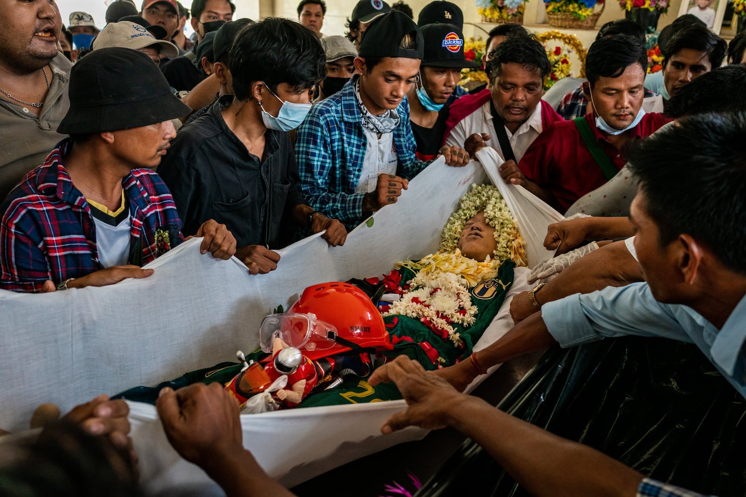 Mourners prepare to carry the body of Aung Kaung Htet, 15, who was killed when military junta forces opened fire on anti-coup protesters, in a coffin during his funeral on March 21, 2021 in Yangon, Myanmar. 