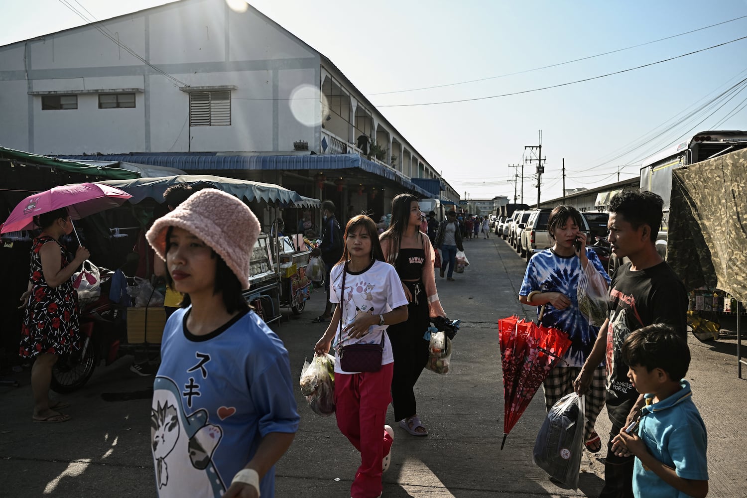 Myanmar migrant workers walk to an outdoor market in Samut Sakhon, Thailand, Jan. 26, 2025.