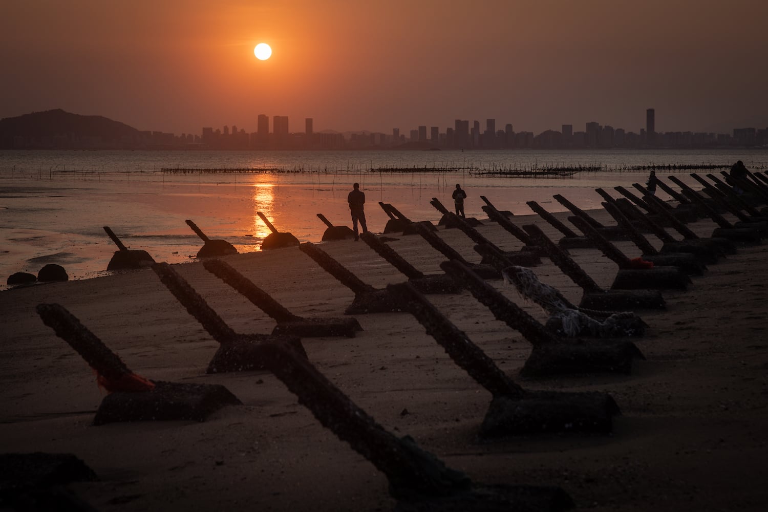 The sun sets over the Chinese city Xiamen as seen from anti-tank fortifications on April 9, 2023 on Kinmen, Taiwan.