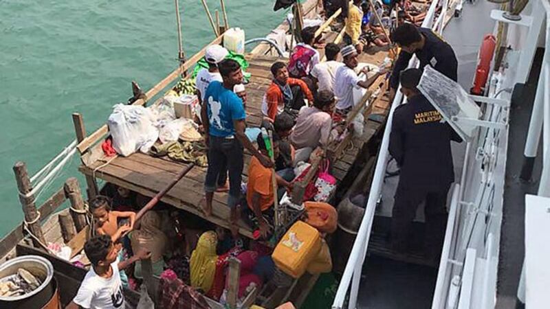 Members of the Malaysian Maritime Enforcement Agency detain a boat carrying dozens of Rohingya refugees from Myanmar in Malaysian territorial waters off the island of Langkawi, Apr. 3, 2018.