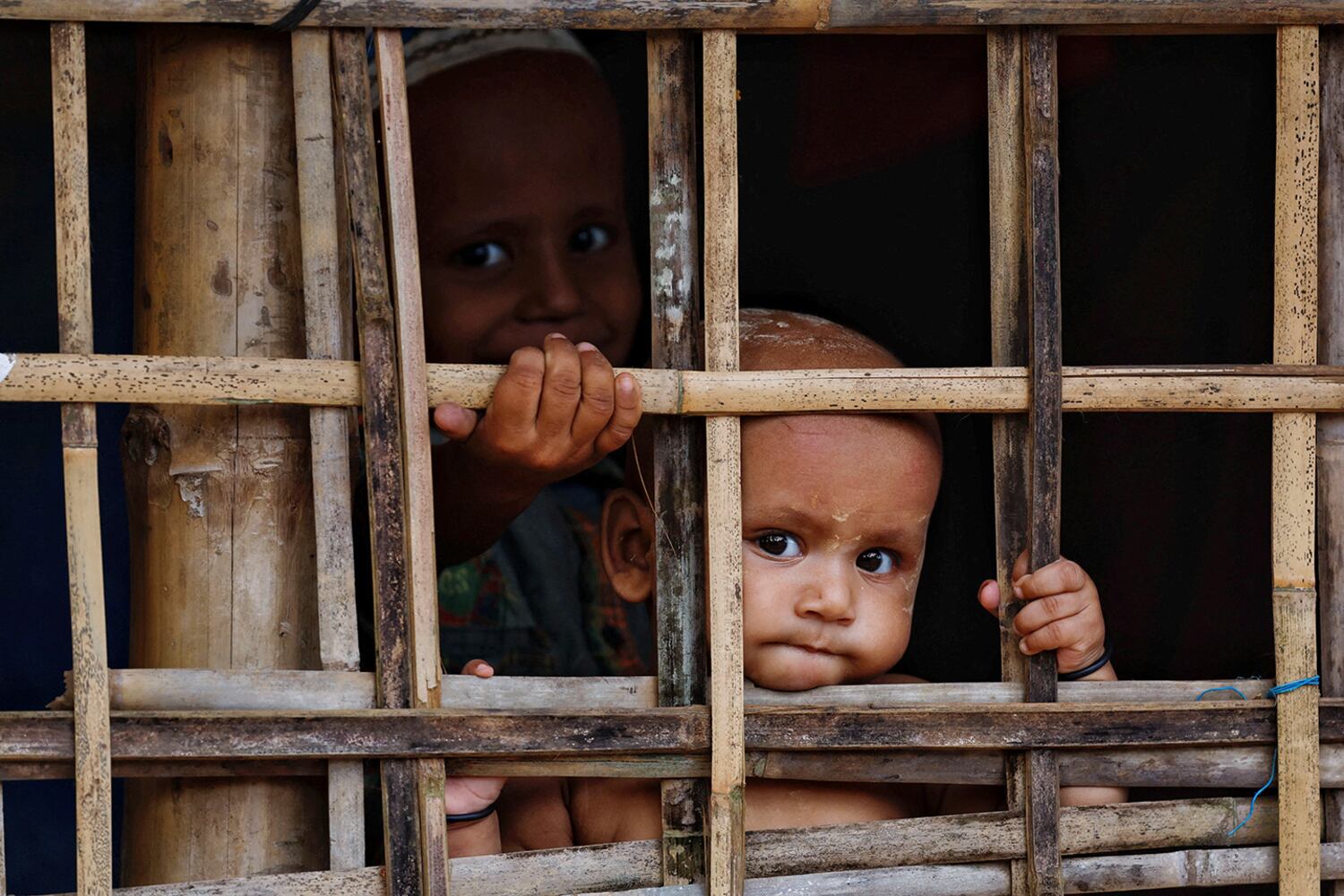 Rohingya refugee children look on from their shelter at a refugee camp in Cox’s Bazar, Bangladesh, Sept. 28, 2024. (Reuters)