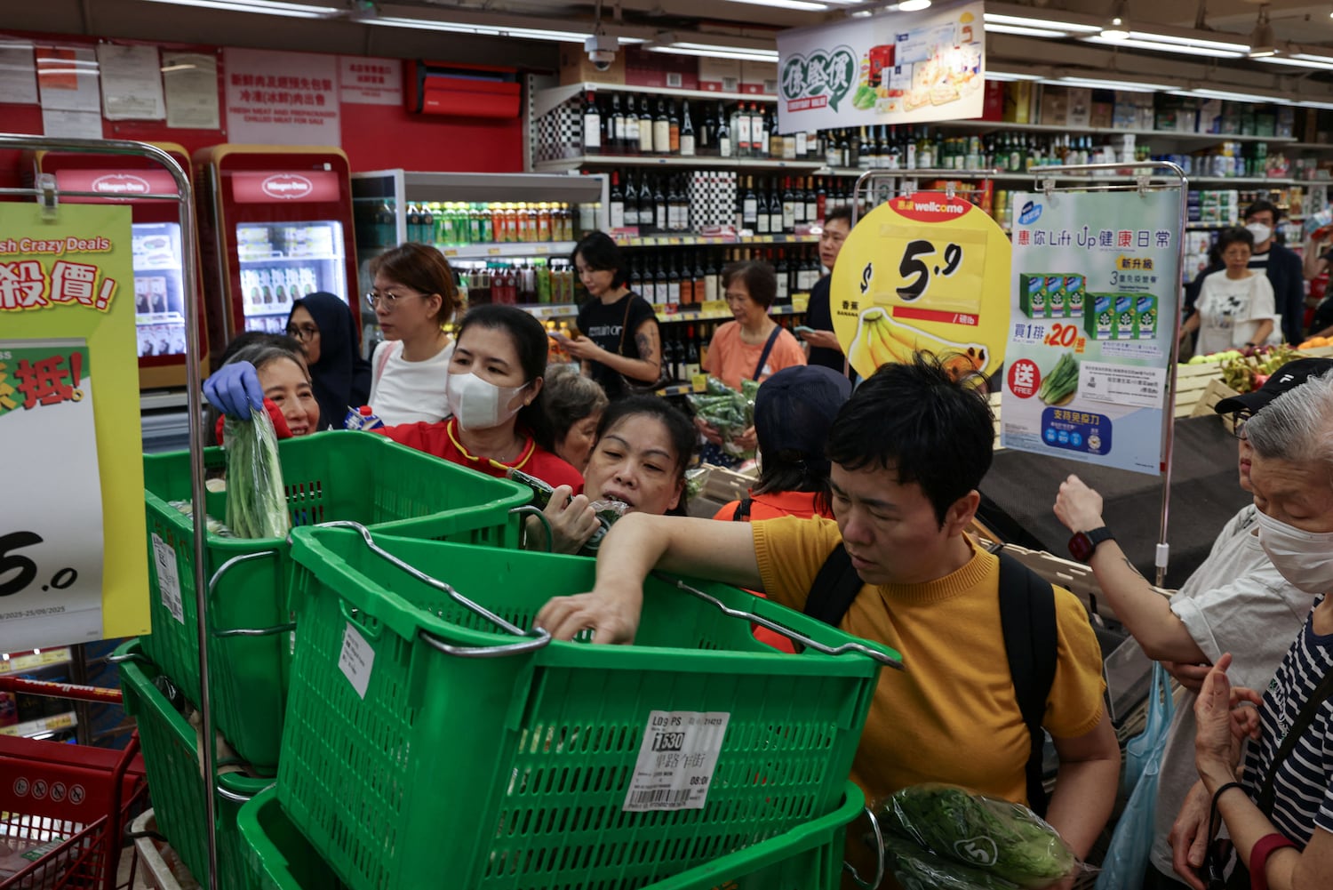 Residents in Hong Kong stock up on supplies at a supermarket to prepare for the approaching Typhoon Ragasa on Sept. 22, 2025.
