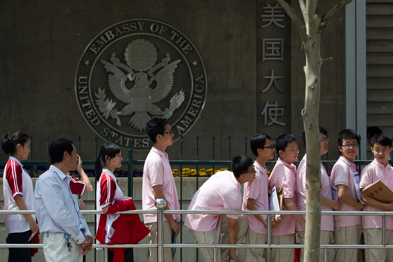 Chinese students wait outside the U.S. Embassy for their visa application interviews on May 2, 2012, in Beijing.