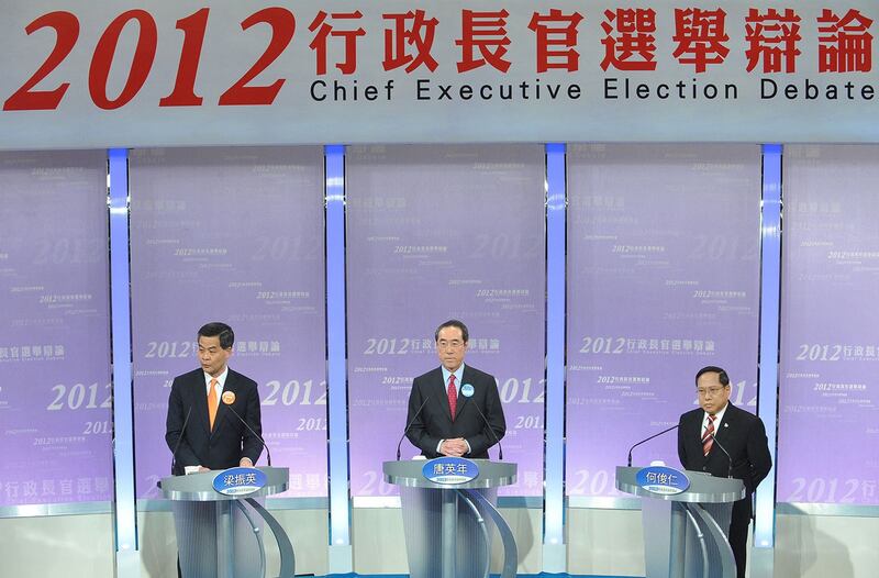 2012年3月16日，梁振英（左）、唐英年（中）、何俊仁（右）举行选举电视辩论。（法新社）
