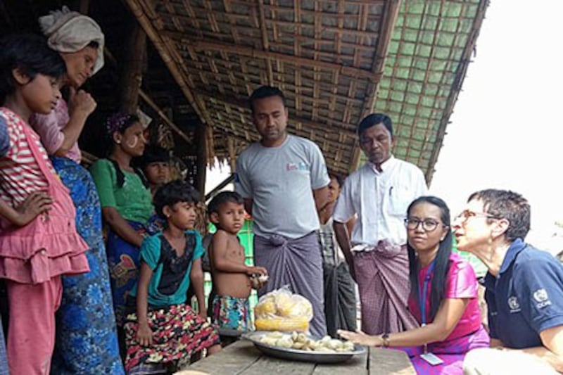 Ursula Mueller (R), the UN's deputy humanitarian chief, talks to Rohingya Muslims at an internally displaced persons camp in Sittwe township, western Myanmar's Rakhine state, April 4, 2018.
