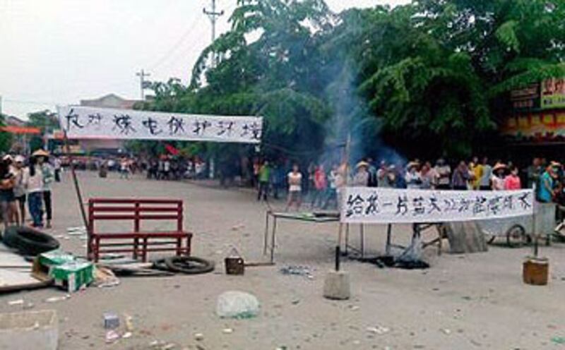 村民一度在村口擺放花圈控訴建煤電廠將污染環境,又高舉抗議橫額與武警對峙。(相片由村民提供)