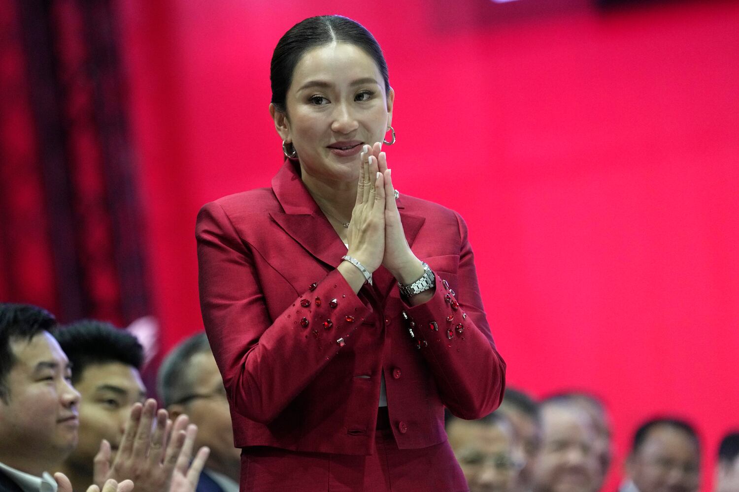 Paetongtarn Shinawatra, daughter of former Thai Prime Minister Thaksin Shinawatra, offers a traditional greeting after her address at Pheu Thai Party headquarters in Bangkok, Oct. 27, 2023. (Sakchai Lalit/AP)