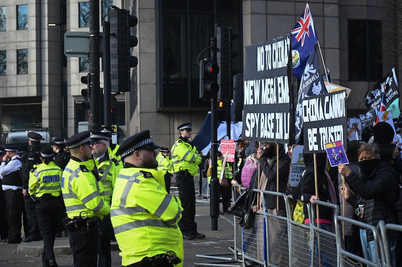 Police watch as protesters gather near the proposed site of the Chinese “mega-embassy” in London, March 15, 2025.
