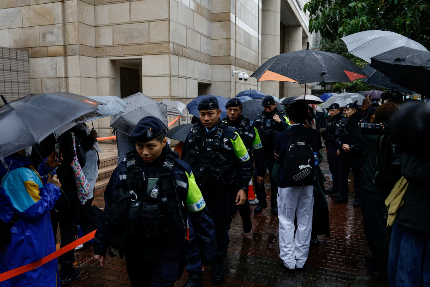 Police patrol outside the West Kowloon Magistrates' Courts building as Jimmy Lai, the founder of the now-defunct pro-democracy newspaper Apple Daily, takes the witness stand for the first time in the national security collusion trial, in Hong Kong, China, Nov. 20, 2024.