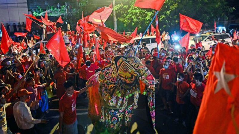Supporters of Myanmar's National League for Democracy celebrate the party's expected election victory with a traditional elephant dance outside NLD headquarters in Yangon, Nov. 10, 2020.