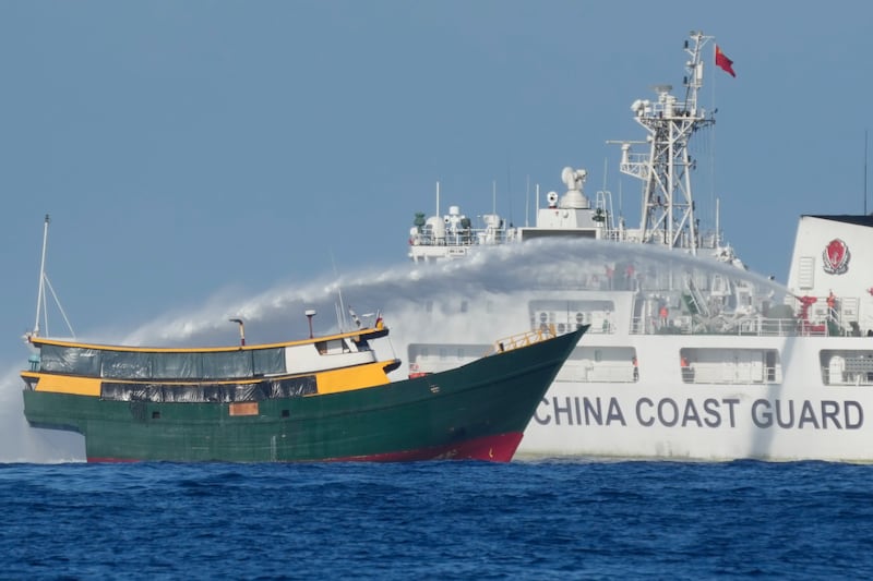 Philippine resupply vessel named Unaizah May 4 (front) is hit by a Chinese Coast Guard water cannon blast near Second Thomas Shoal, South China Sea, March 5, 2024. [Aaron Favila/AP