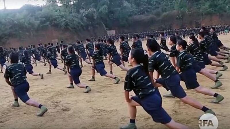 Female Arakan Army recruits exercise as part of their training regimen in northern Myanmar's Kachin state in an undated photo.