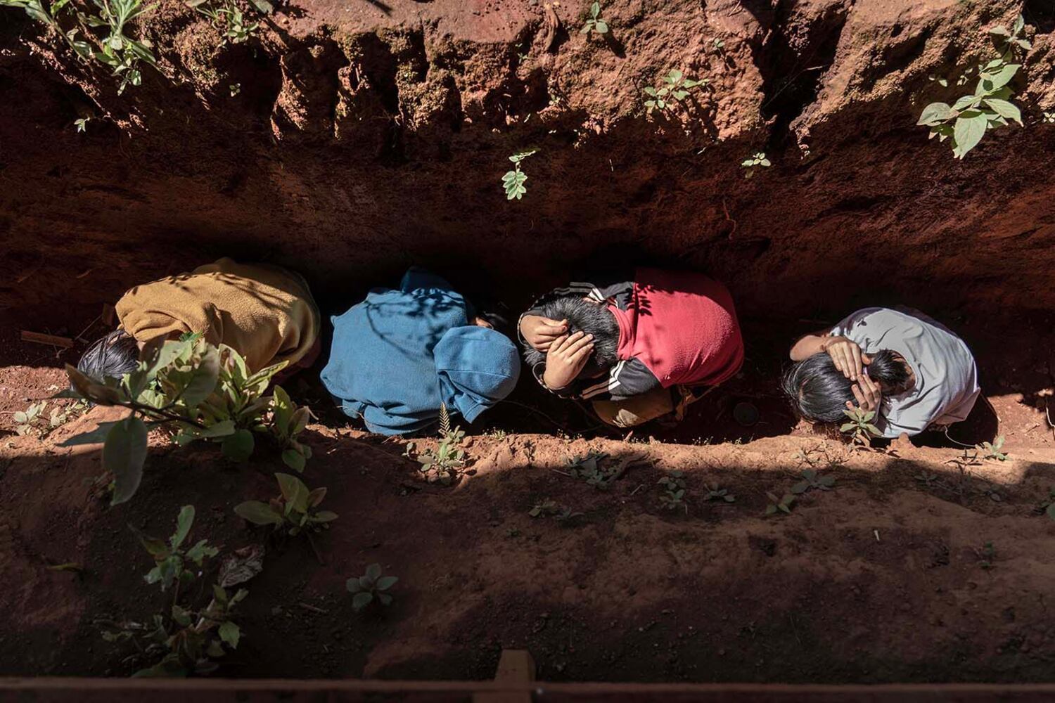 Children hide in a makeshift bomb shelter during a drill at a newly built school in southern Shan state, Myanmar, Nov. 4, 2024.