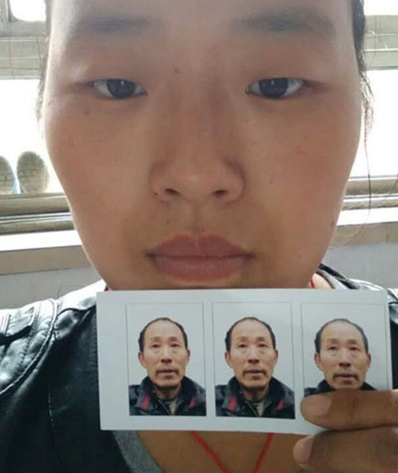 Liu Xia displays a photo of her father at her home in Hebei's Dingzhou city, in an undated photo. Credit: Liu Xia