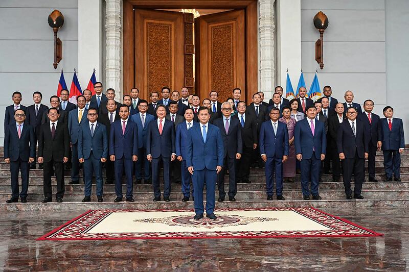 Cambodia's Prime Minister-designate Hun Manet, center, and incoming cabinet members pose for a group photo at the headquarters of the Cambodian People's Party in Phnom Penh, Aug. 10, 2023. (Kok Ky/Cambodia's Government Cabinet via AFP)
