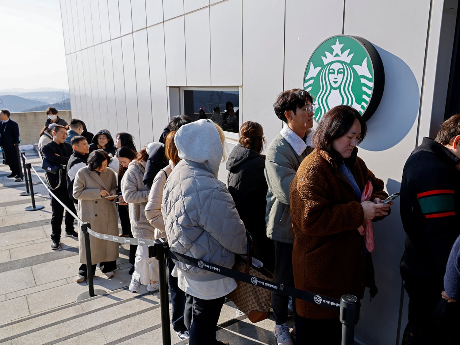 Customers wait to enter the Starbucks at the top of the Aegibong Peak Observatory, south of the demilitarized zone (DMZ), separating the two Koreas, in Gimpo, South Korea, Nov. 29, 2024.