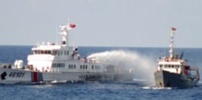 Tàu Cảnh sát biển Trung Quốc (T) phun vòi rồng vào tàu VN trên vùng biển gần giàn khoan HD 981 hôm 07/5/2014. AFP photo