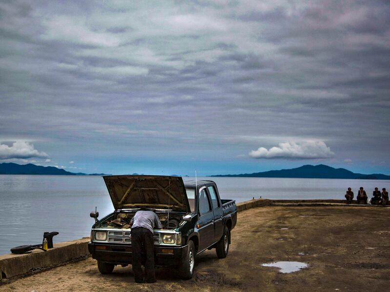 A man works on  his car in Chongjin City, North Korea in this undate photo.