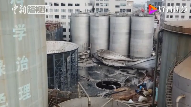 现场视频显示,爆炸现场昏暗,地上堆着各类大小杂物,被污染的布料呈黑褐色。(网络视频截图)