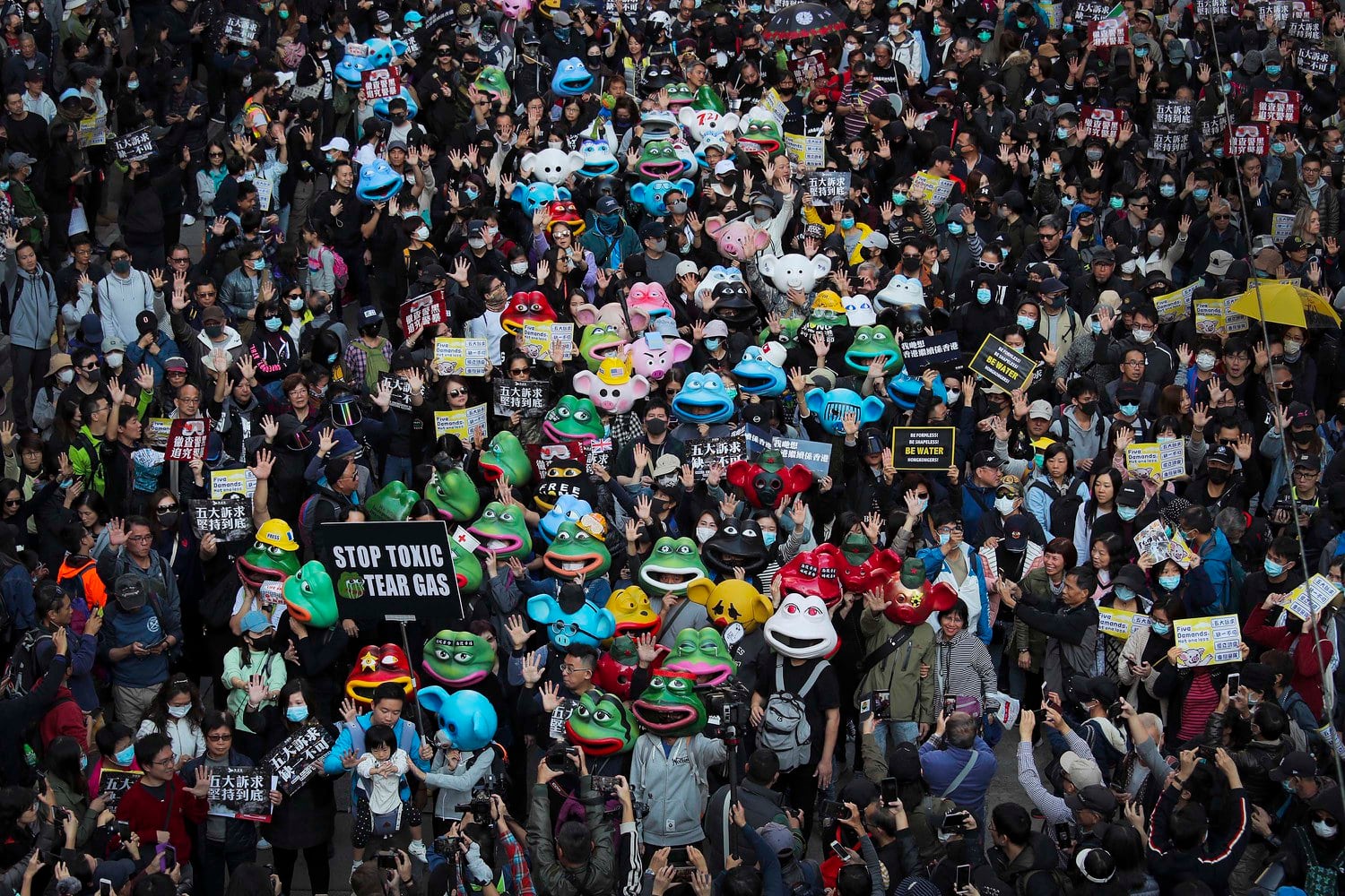 Pro-democracy protesters march in Hong Kong in 2019. Credit: Kin Cheung/AP