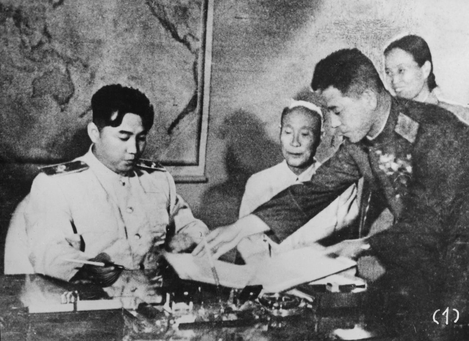 North Korean leader Kim Il Sung signs the Korean Armistice Agreement at Pyongyang, North Korea, assisted by General Nam Il.