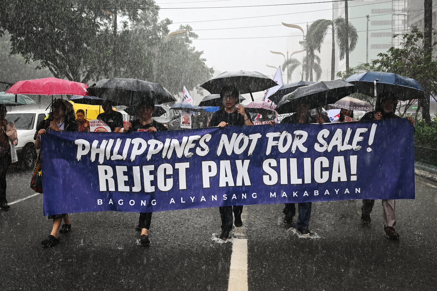 People march as they protest against Pax Silica, a U.S.-led initiative, in Manila on August 13, 2026.