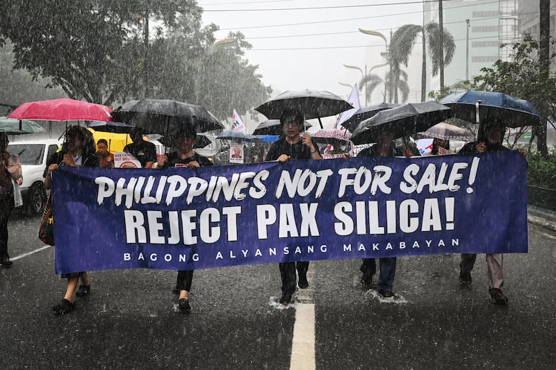 People march as they protest against Pax Silica, a U.S.-led initiative, in Manila on August 13, 2026.