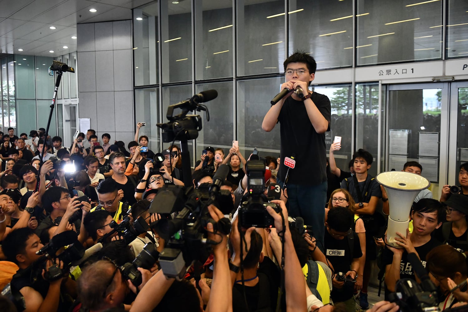 Pro-democracy activist Joshua Wong speaks to the media and supporters outside the Legislative Council shortly after being released from prison on June 17, 2019 in Hong Kong. (Carl Court/Getty Images)