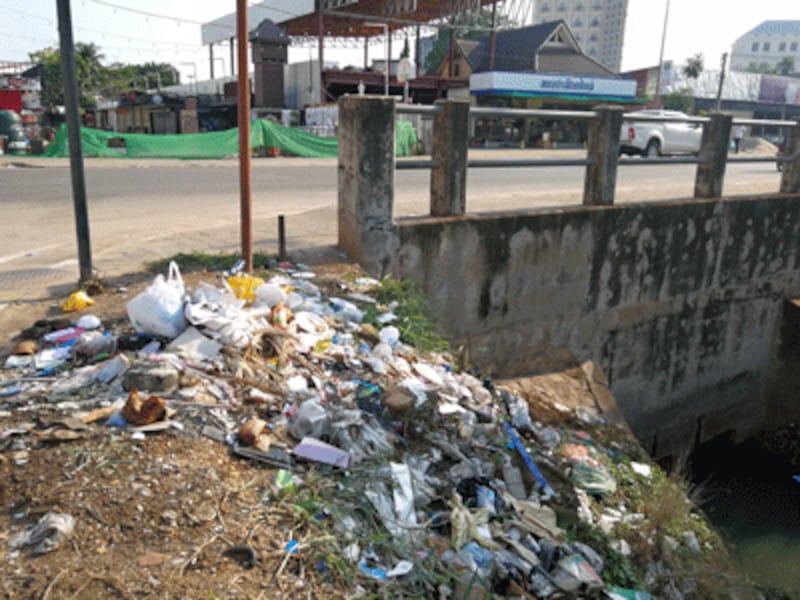 Trash litters the side of a road in Vientiane, Laos, in an undated photo.