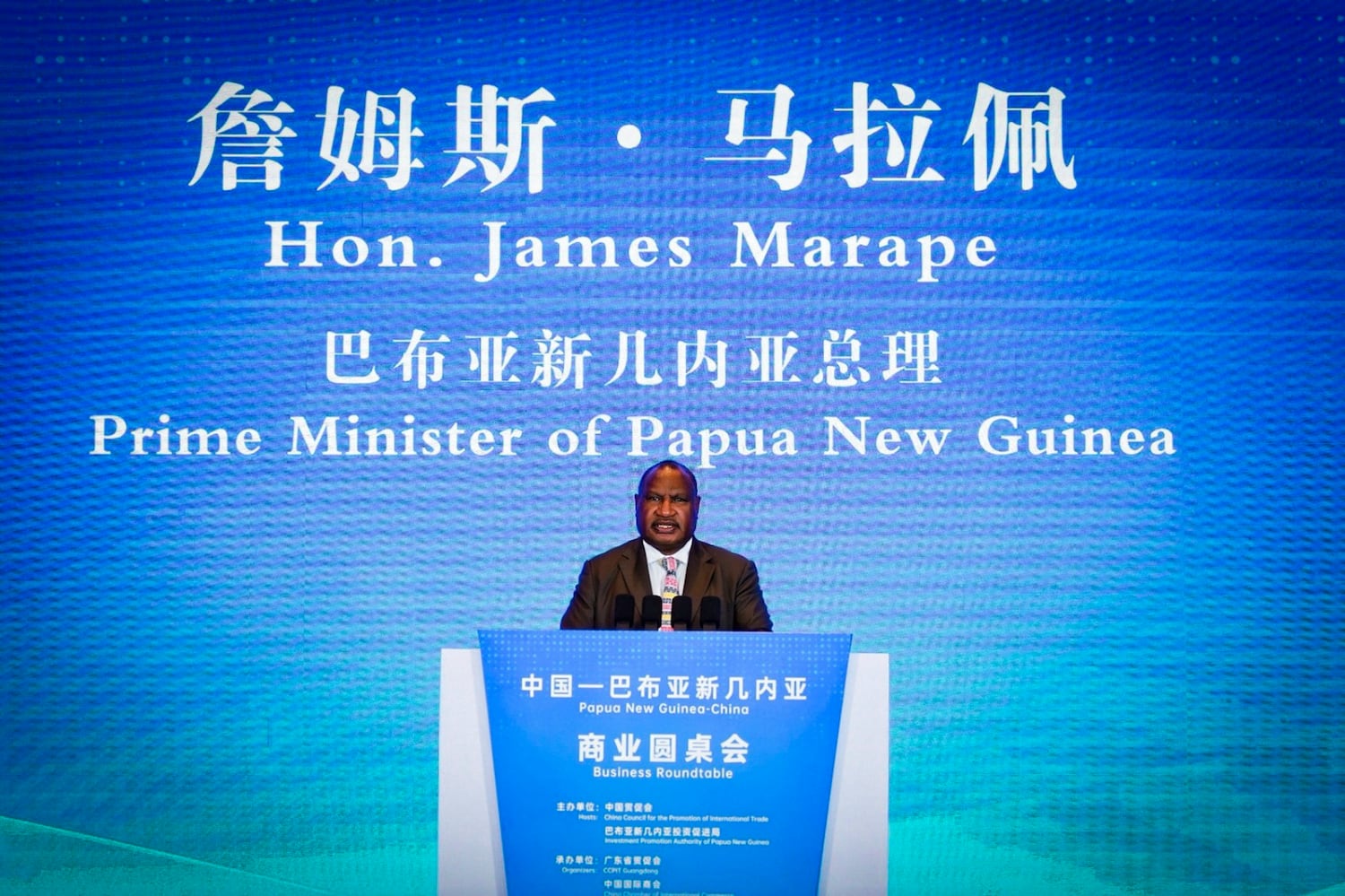 In the image released by the Chinese government, PNG Prime Minister James Marape addresses a gathering of business leaders in Guangzhou, China, April 29, 2026.