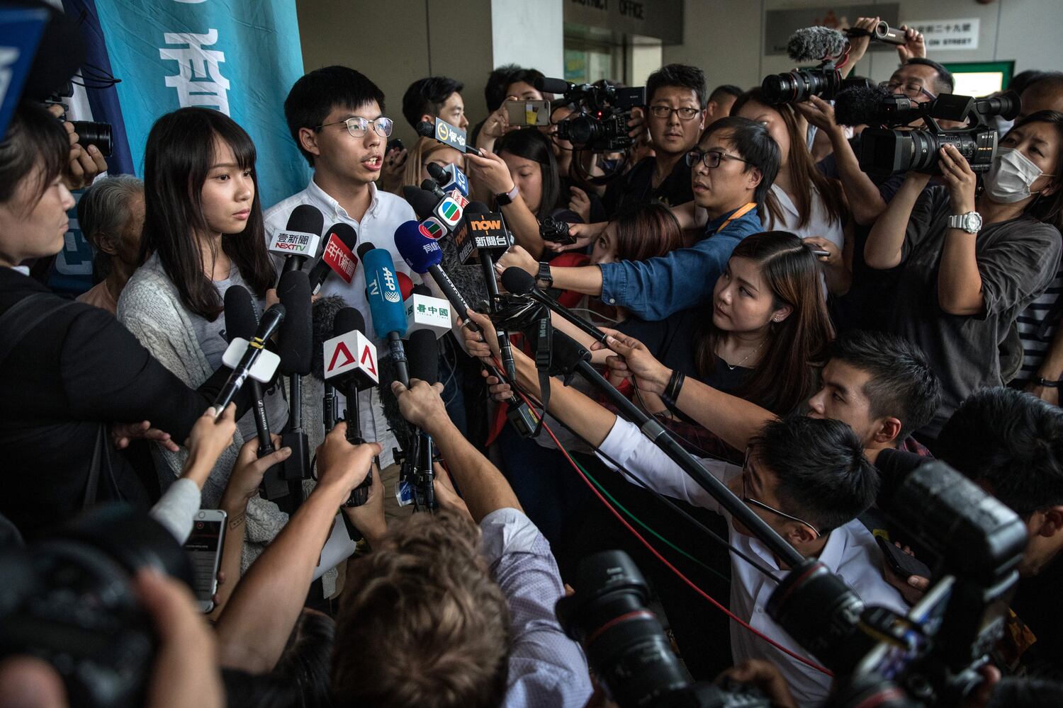 Hong Kong pro-democracy activists Agnes Chow, left, and  Joshua Wong speak to the media after being arrested and released on bail on August 30, 2019 in Hong Kong. (Chris McGrath/Getty Images)