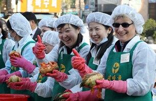 서울 성북구청 앞마당에서 열린 주한외국인 초청 김장 행사에 참가한 외국인들이 직접 만든 김치를 들고 기념촬영을 하고 있다.
