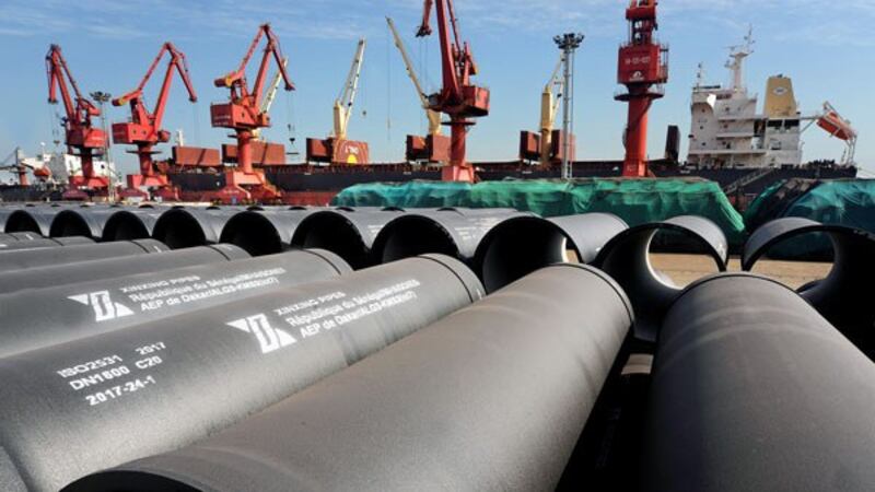 Cranes prepare to load steel pipes for export at a port in Lianyungang in coastal China's Jiangsu province, May 31, 2018.