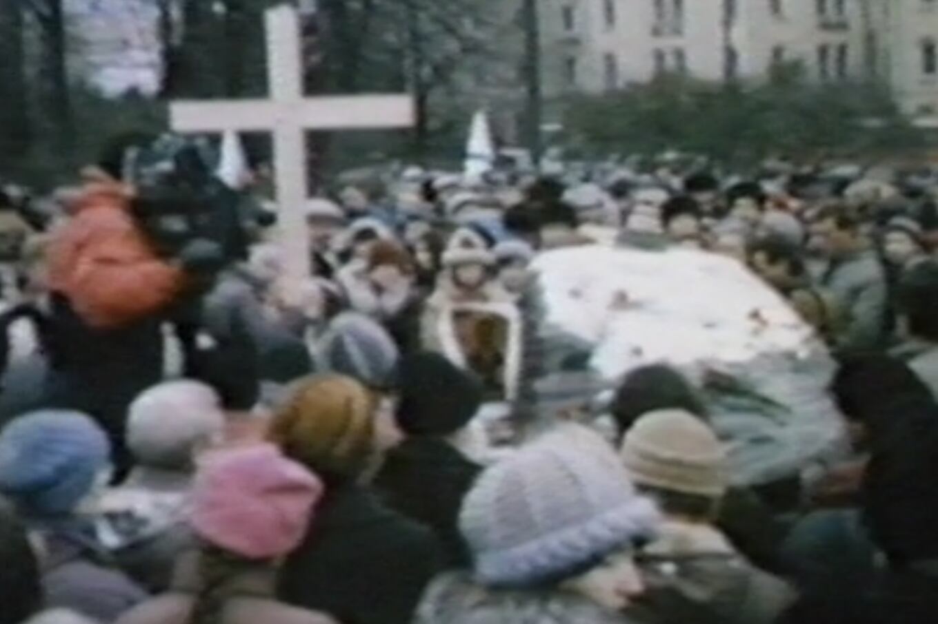 1991年11月7日,苏联民众手执蜡烛,在墓碑基座摆放鲜花,在神父戴领下,在胸前划着十字,为斯大林暴政下数以千万记的受害者举行祈祷和祭奠仪式。