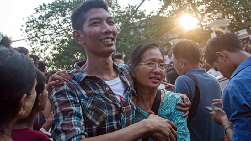 A Myanmar woman (R) greets her son (L) after he is released from Insein Prison as part of a presidential amnesty for prisoners during the Buddhist New Year, in Yangon, April 17, 2019.