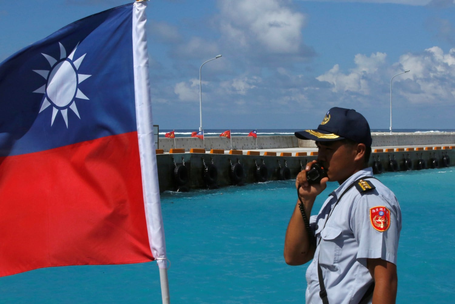 A file photo showing a member of the Taiwanese Coast Guard standing guard next to a Taiwanese flag on Itu Aba, which the Taiwanese call Taiping, at the South China Sea, Nov. 29, 2016.