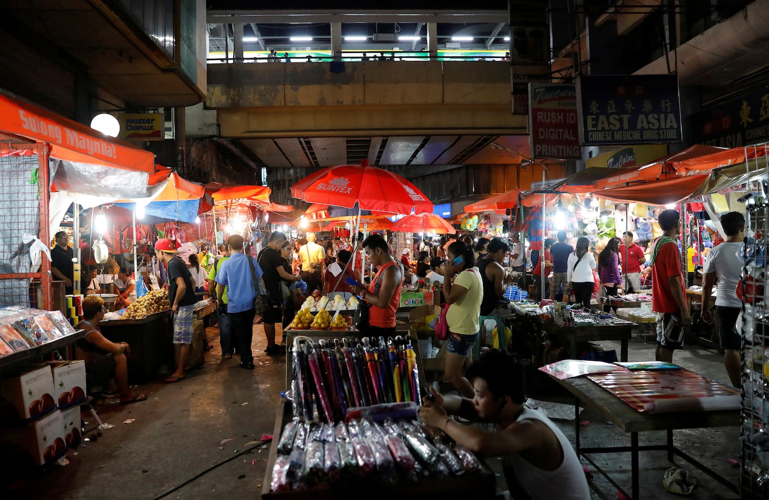 In a file photo, vendors sell their wares at a local downtown district of Metro Manila, Philippines, September 15, 2017.
