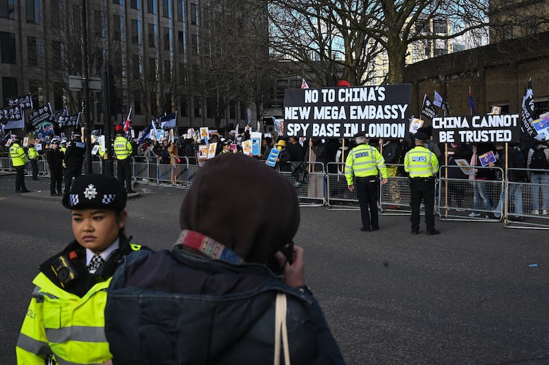 Police watch as protesters gather near the proposed site of the Chinese “mega-embassy” in London, March 15, 2025.