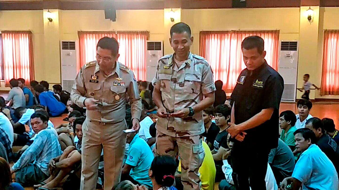 Thai officers talks to refugee and asylum seekers in Bangkok, Thailand, Aug. 28, 2018.