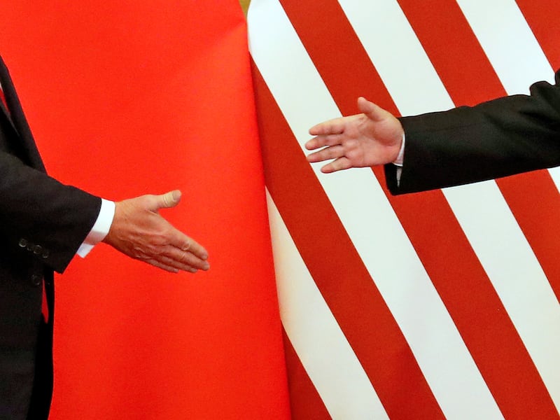 President Donald Trump and China's President Xi Jinping shake hands at the Great Hall of the People in Beijing, China, Nov. 9, 2017.