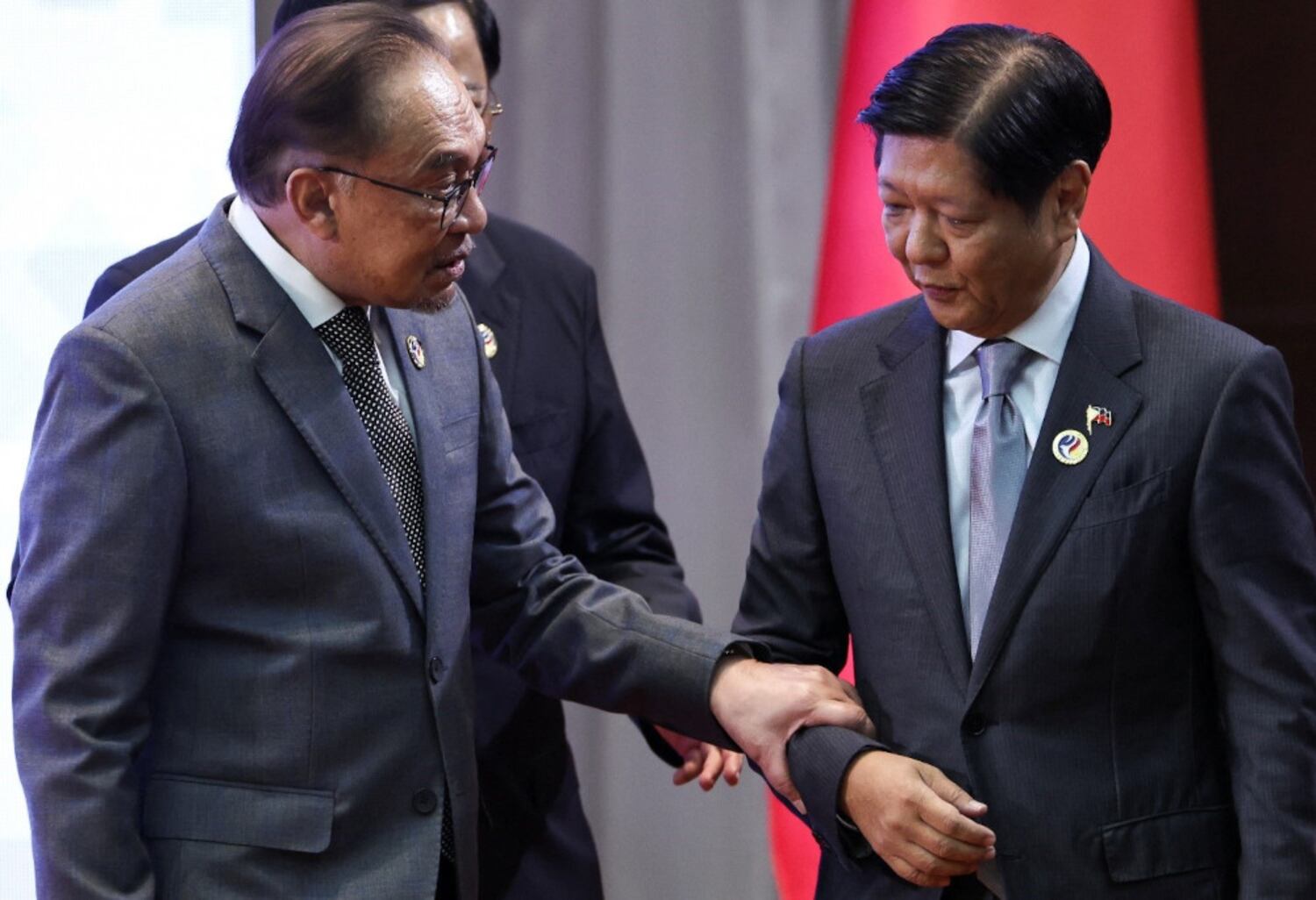 Malaysian Prime Minister Anwar Ibrahim (left) speaks with Philippine President Ferdinand Marcos Jr. as they attend the 27th ASEAN-China Summit at the National Convention Centre in Vientiane, Oct. 10, 2024.