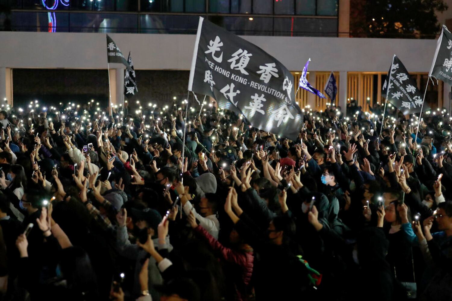 Protesters hold up their hands to symbolize the five demands of the pro-democracy movement during a rally in Hong Kong, Dec. 23, 2019.