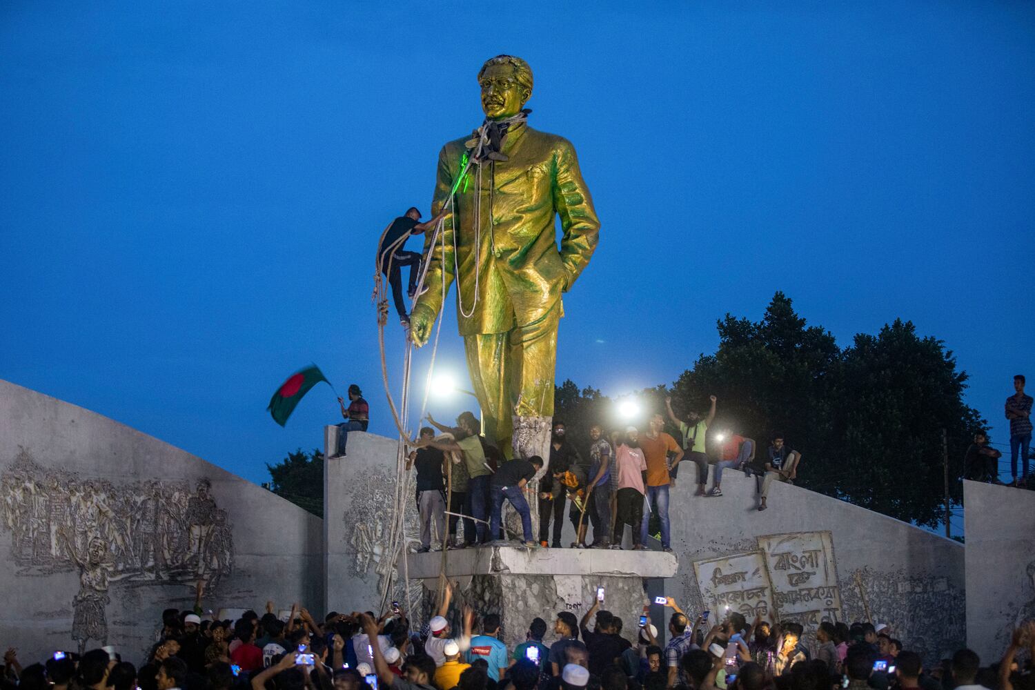 Protesters try to demolish a large statue of Sheikh Mujibur Rahman, father of Bangladesh leader Sheikh Hasina and the nation’s founding leader, after she resigned as prime minister, in Dhaka, Aug. 5, 2024. (Rajib Dhar/AP)