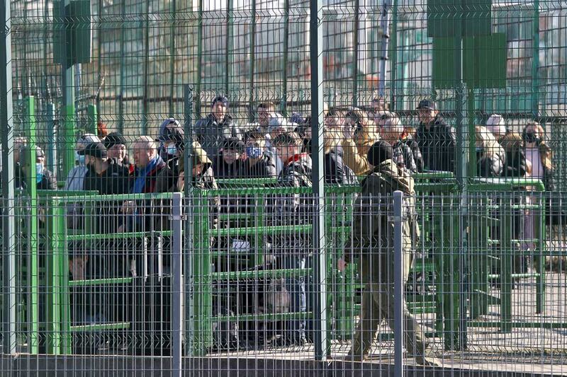 People wait at the Ukrainian side of the border crossing between Poland and Ukraine following the launch of Russia's military operation Feb. 24, 2022. (Reuters)